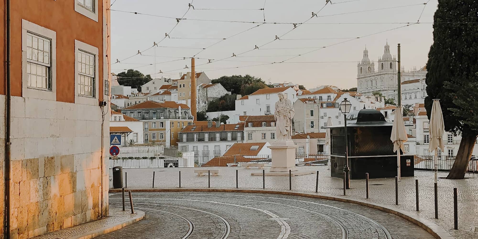 Cobbled street with tram tracks in charming Alfama, Lisbon